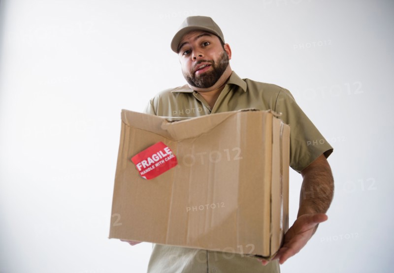 Delivery man holding damaged cardboard box