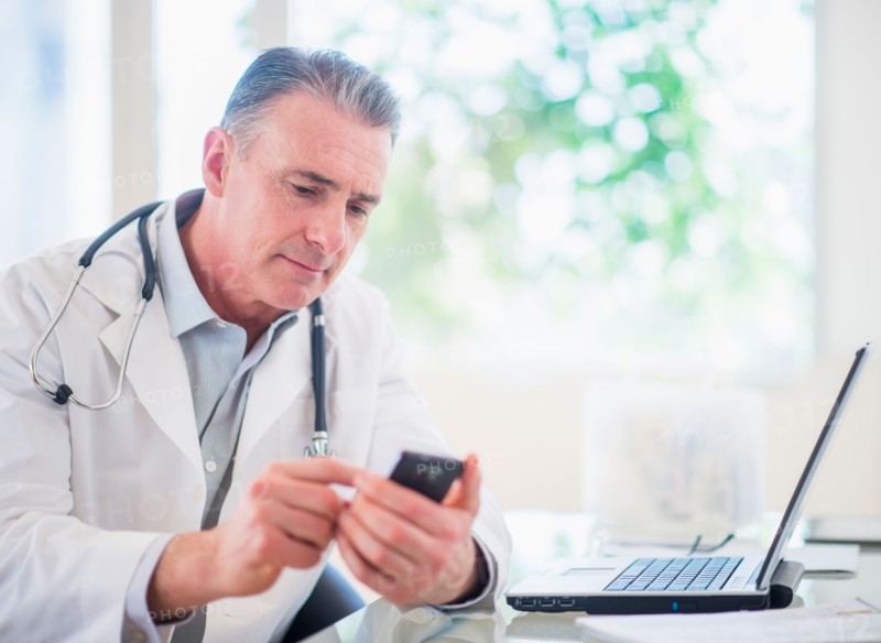 Portrait of doctor using mobile phone