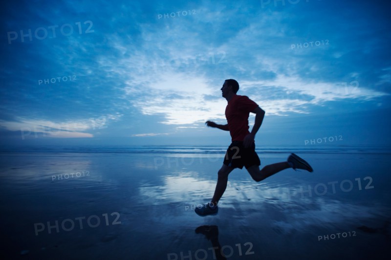 Man running along beach
