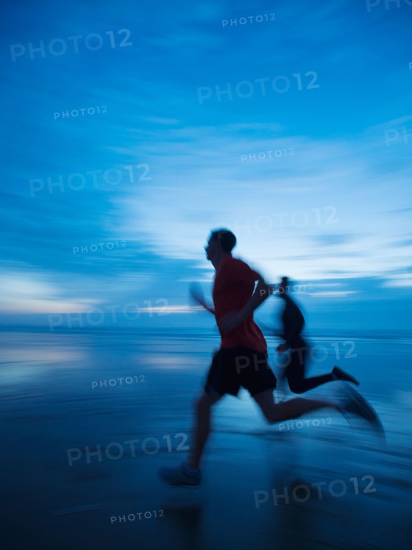 Man running along beach
