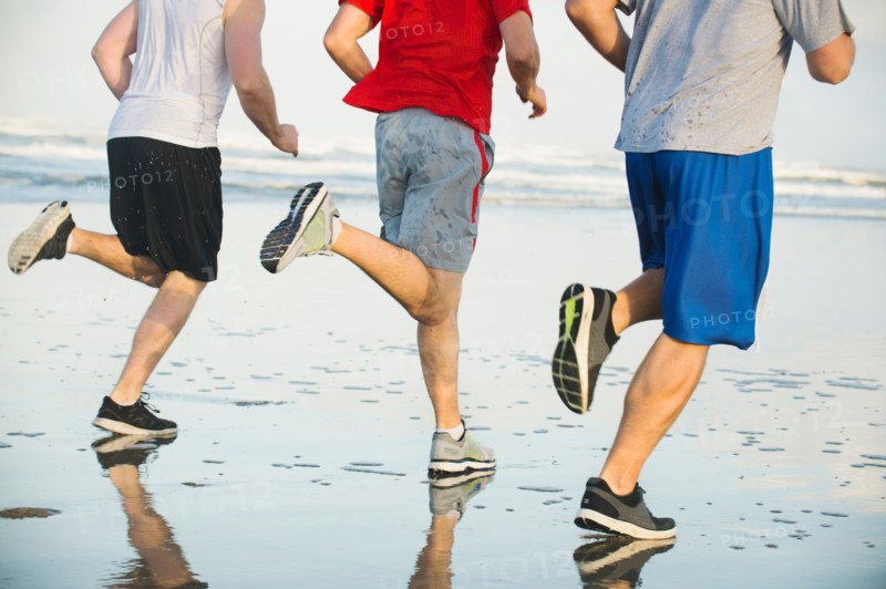 Men running on beach