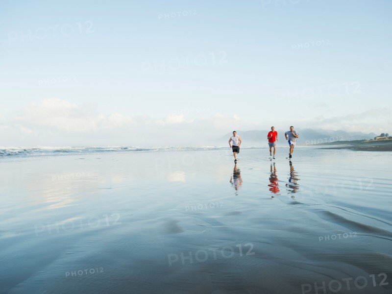 Men running on beach