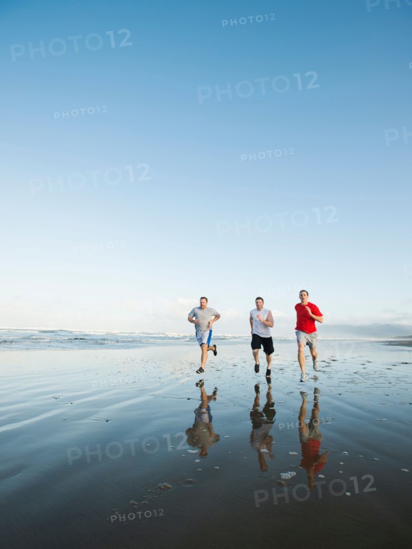 Men running on beach