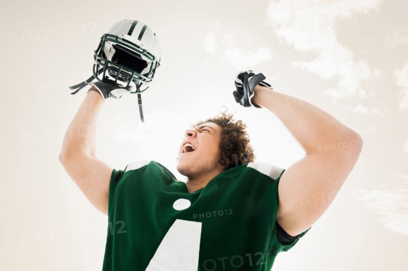 Portrait of American football player celebrating victory