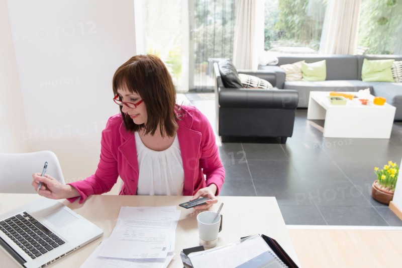 Mature businesswoman doing paperwork