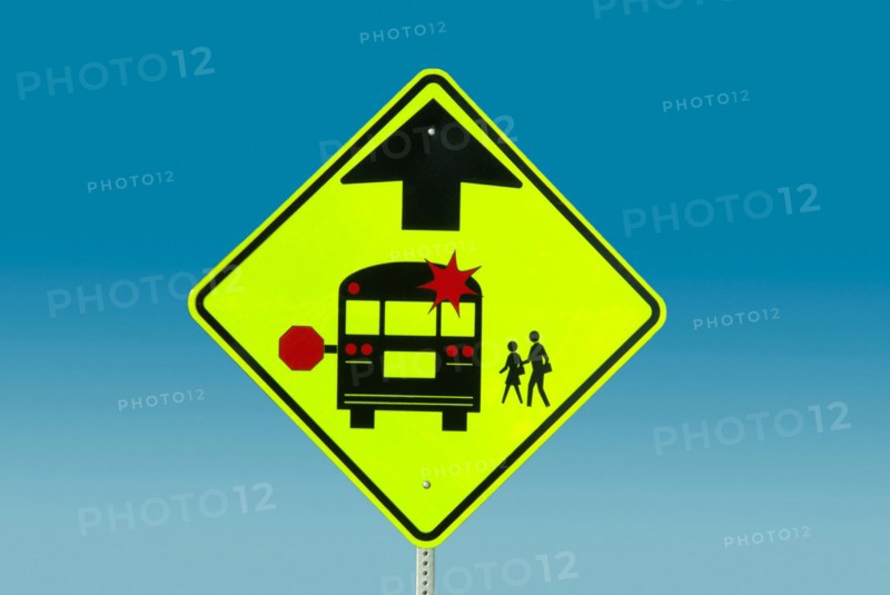 Warning sign against blue sky