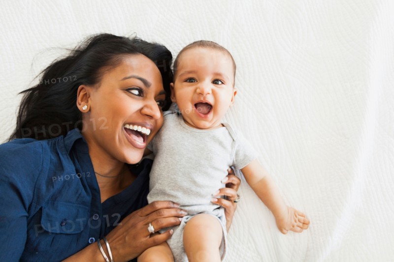 Mother with baby boy (2-5 months) hugging and laughing