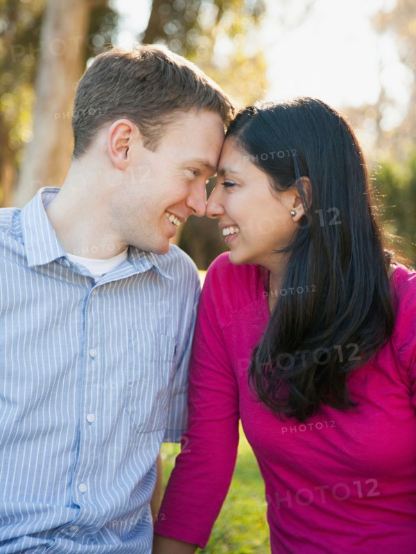Couple sitting on grass in park