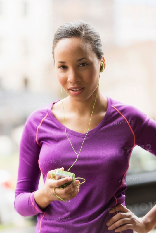 Portrait of female jogger with mp3 player.