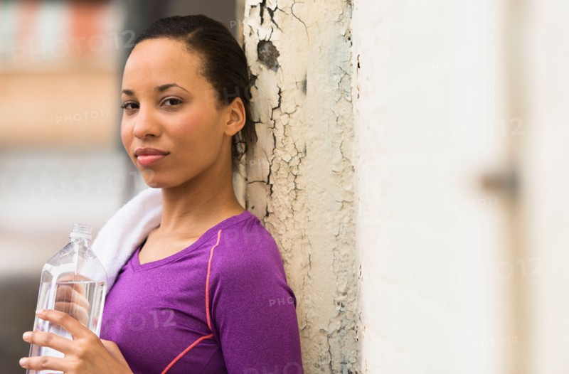 Portrait of female jogger with water bottle.