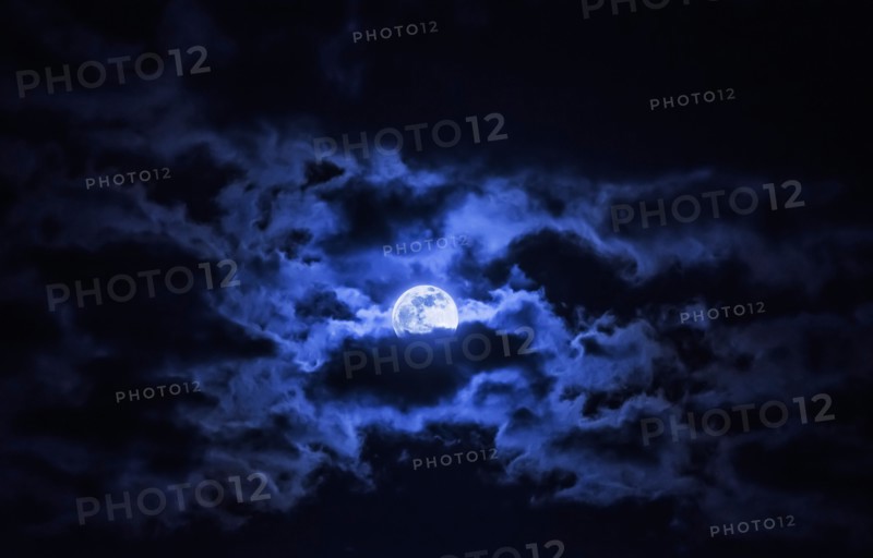 Dramatic sky with full moon.