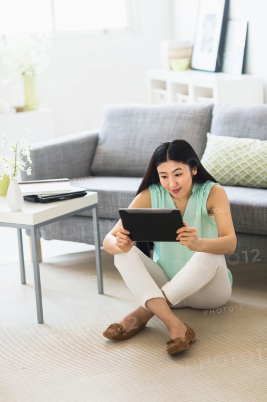 Woman using tablet pc at home.