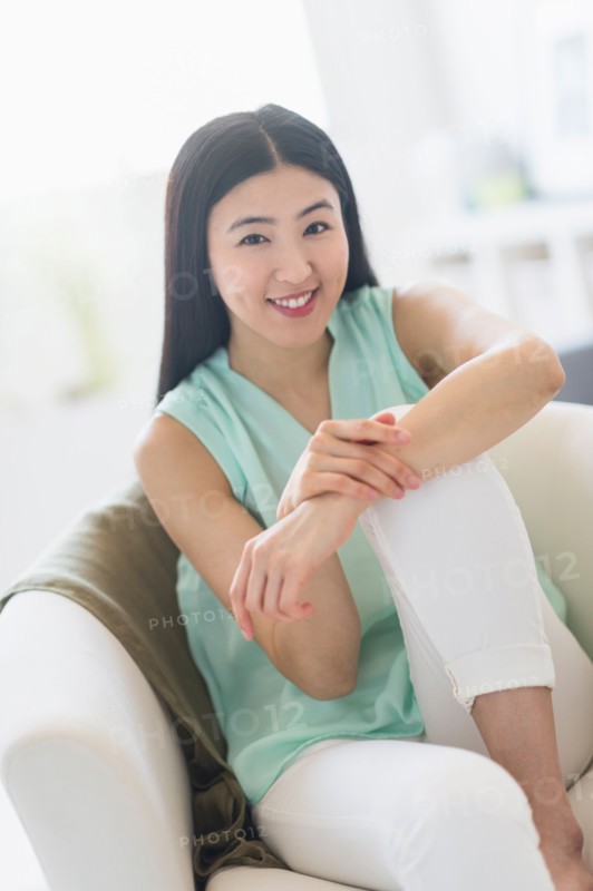 Portrait of woman sitting in armchair.
