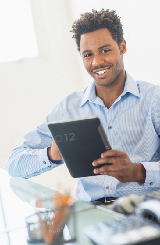 Businessman using tablet PC in office.