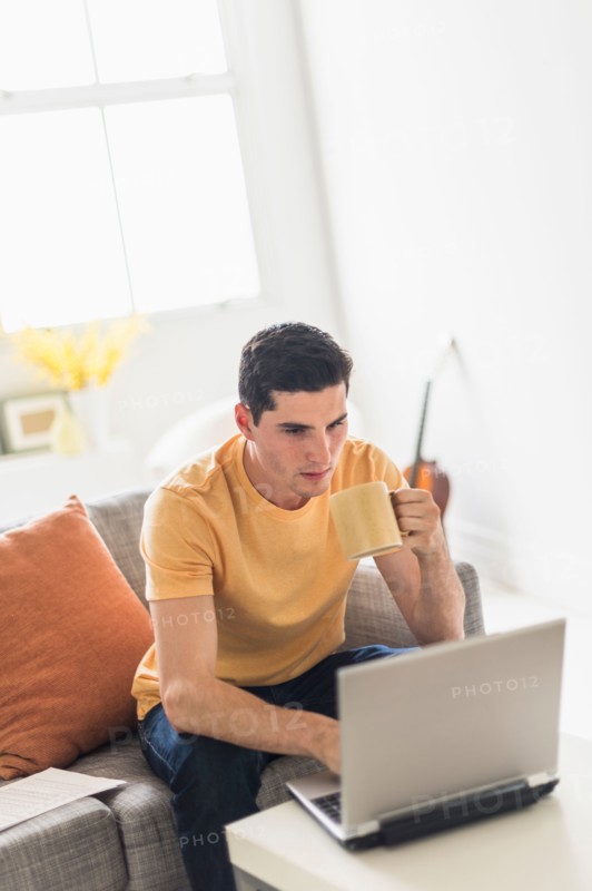 Man using laptop at home.