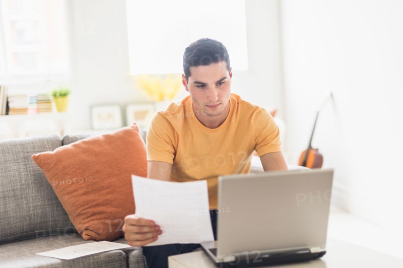Man using laptop at home.