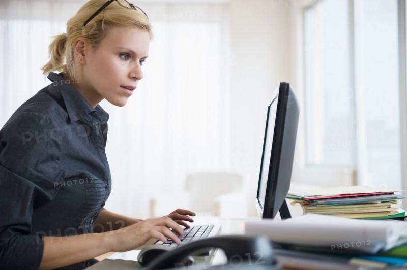 Young woman working at desk in office