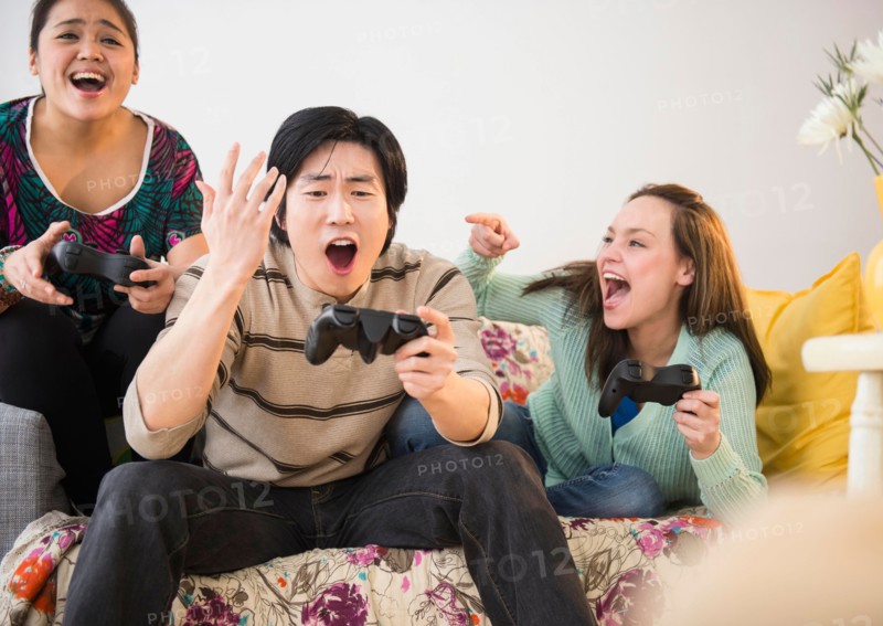 Young women and man playing video game