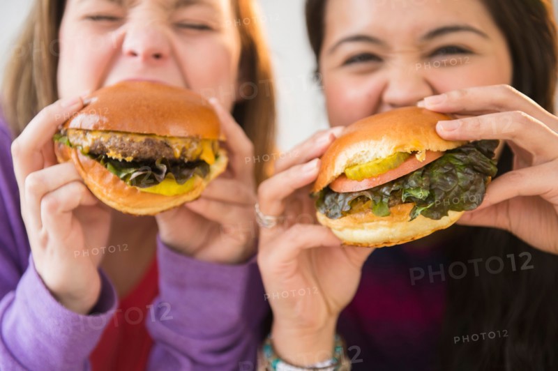 Young women eating hamburgers