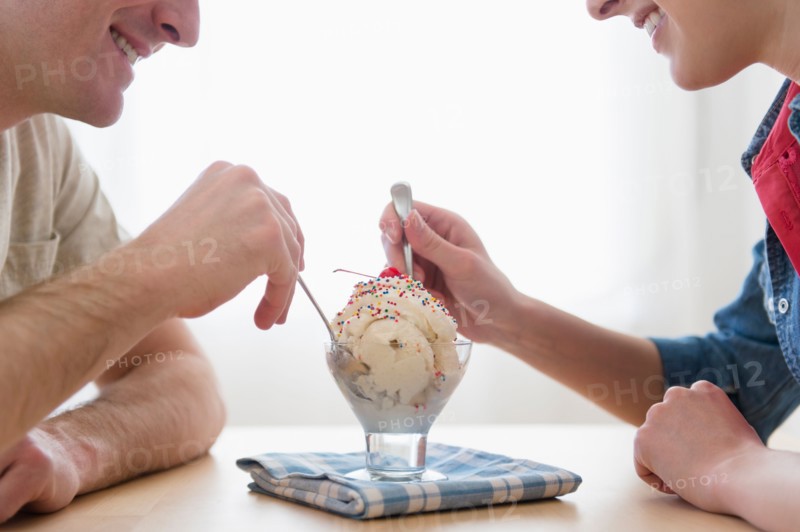 Couple eating one bowl of ice-cream