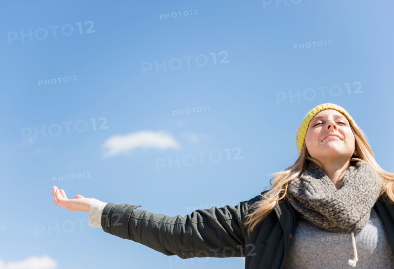 Young woman under blue sky