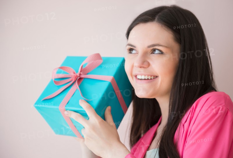 Young woman holding gift box