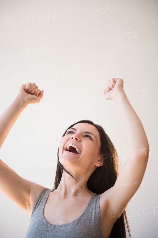 Young woman in victorious gesture