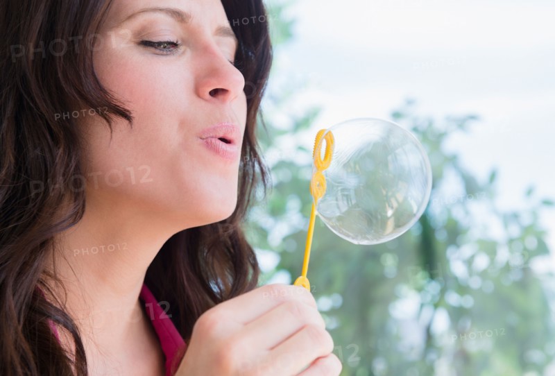 Portrait of woman blowing bubble