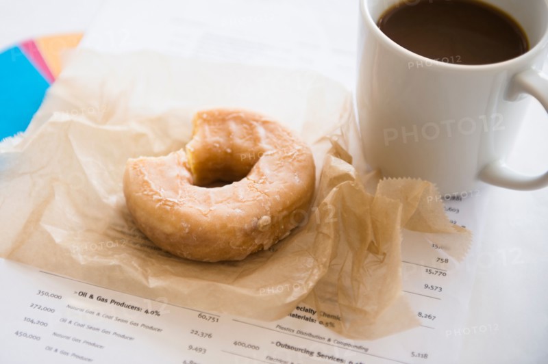 Studio Shot coffee and donut on documents