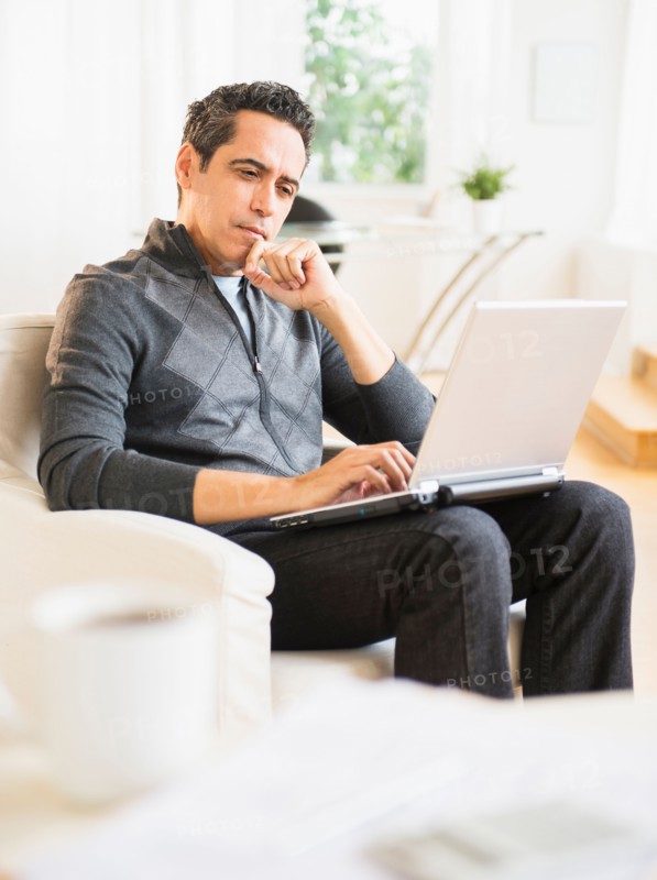 Portrait of man working on laptop at home