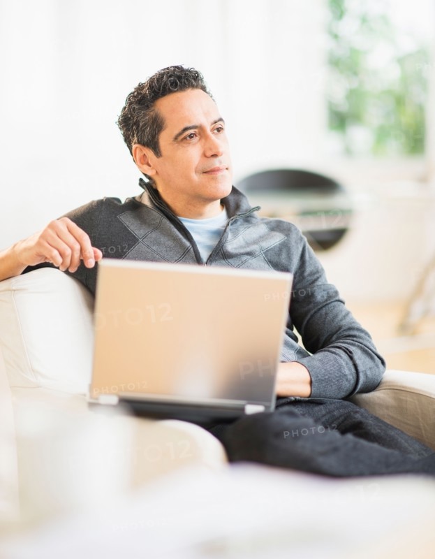 Portrait of man working on laptop at home
