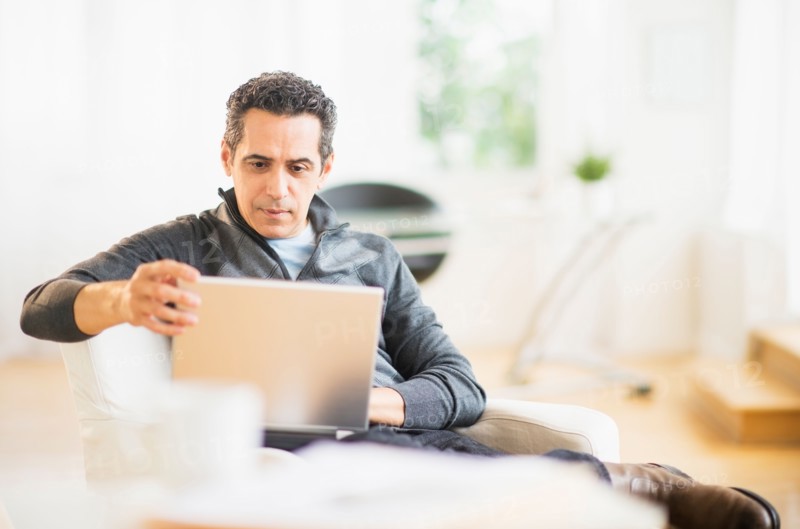 Portrait of man working on laptop at home
