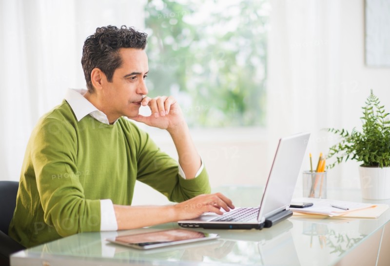 Portrait of man working on laptop at home