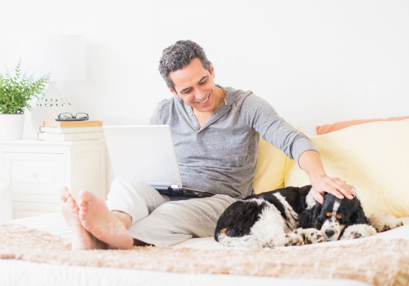 View of mature man using laptop at home