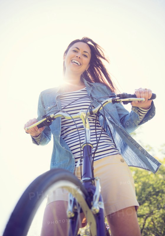 Portrait of mid adult woman with bicycle