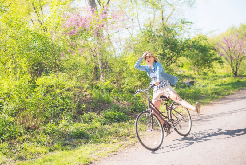 Mid adult woman riding bicycle