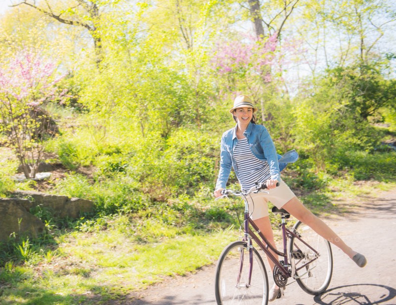 Mid adult woman riding bicycle