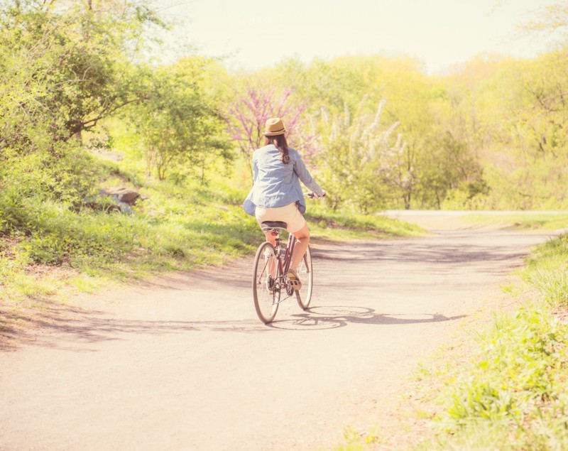 Mid adult woman riding bicycle