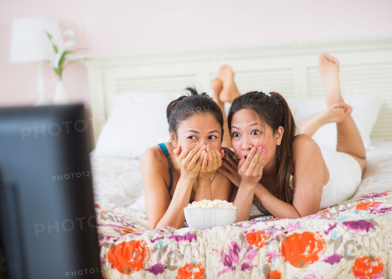 Two women watching tv