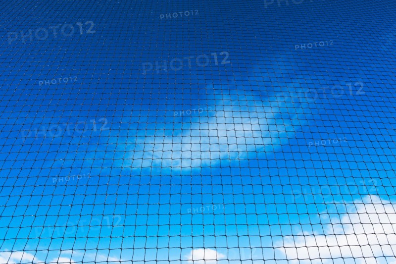 Grid-wire fence against sky