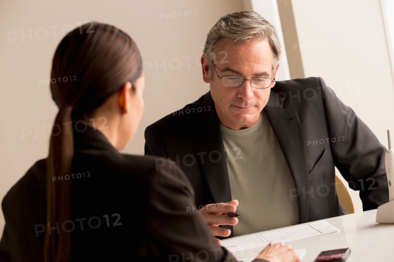 Mature man and woman working together