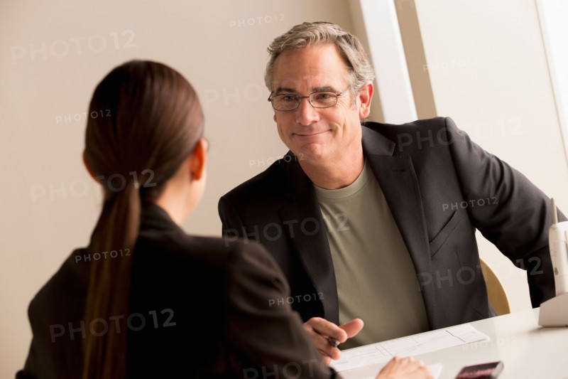 Mature man and woman working together