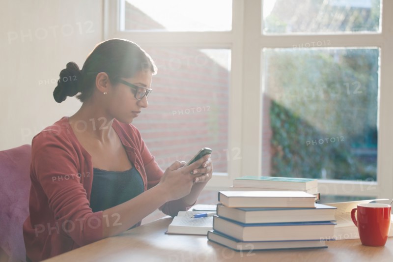 Young woman having coffee break during studying