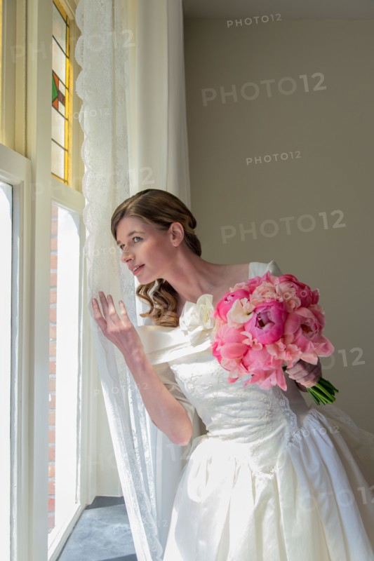 Bride looking out window