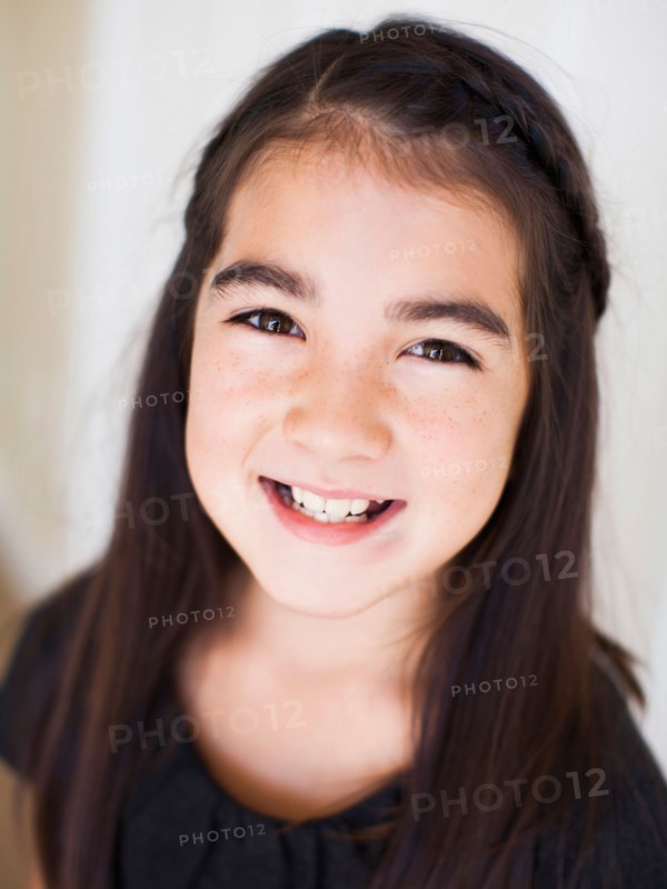 Portrait of girl (8-9) laying on bed