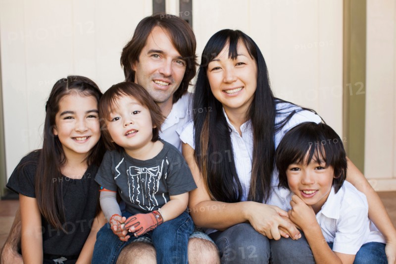 Portrait of family with three kids (2-3, 8-9)