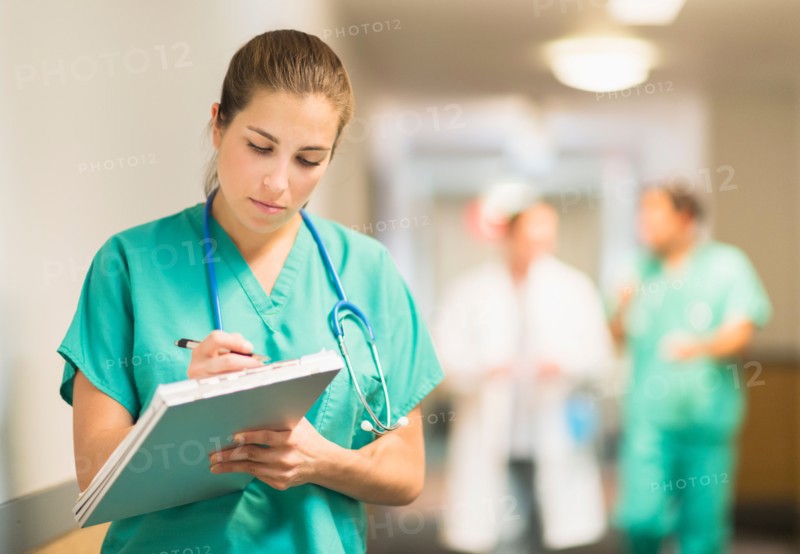 Female doctor in hospital hallway.