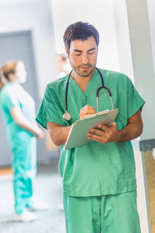 Male doctor in hospital hallway.