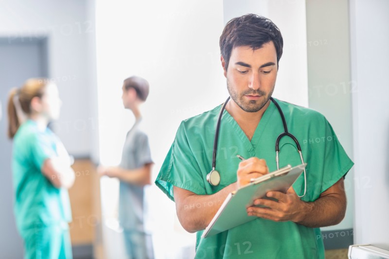 Male doctor in hospital hallway.