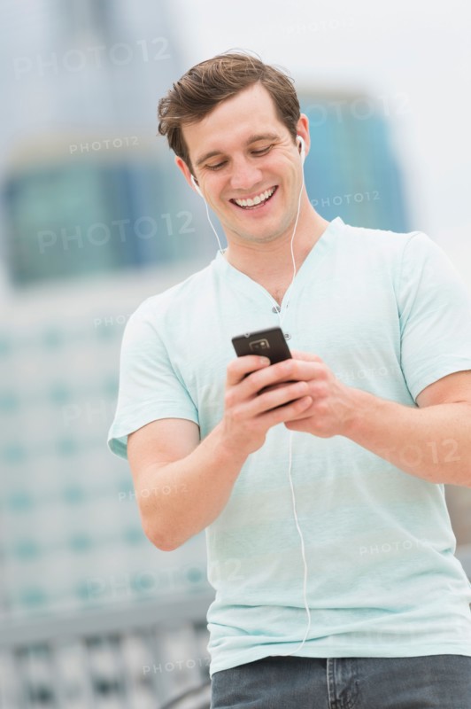 Man listening to music on smartphone.
